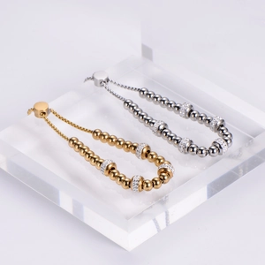 Adjustable beaded stainless steel bracelets with rhinestone charms in gold and silver