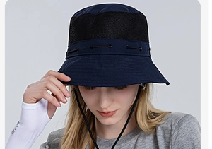 Close-up of dark blue outdoor bucket hat with large breathable black mesh panels and chin strap