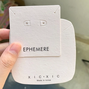 Detail of custom beige jewelry display cards featuring Korean-made brand logo branding