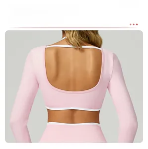 Detail of light pink yoga top featuring a hollow U-shaped back and contrast piping