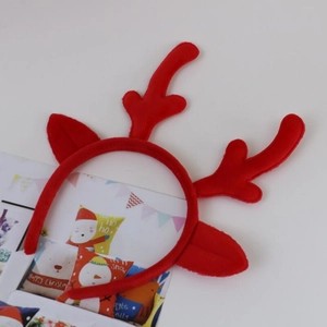Detail shot of a red plush reindeer antler headband with festive Christmas themed cards