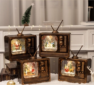 Detail showing vintage TV-style Christmas snow globes with festive interior scenes