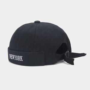Detail of NEWYORK embroidery on black cotton docker hat with adjustable metal buckle