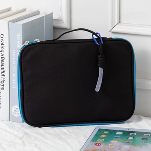 Detail of black laptop sleeve with blue zipper and handy top handle for portability