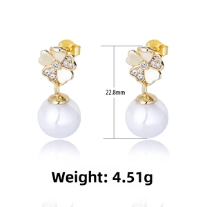 Close-up of S925 silver floral earrings with sparkling diamonds and white pearls
