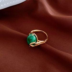 Detailed close-up of a vintage gold plated ring featuring an oval green malachite stone