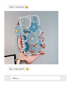 Detail of transparent iPhone case with blue floral print and matching beaded wrist strap