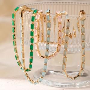 Colorful glass bead bracelet featuring rectangular cut gemstones and gold chain links