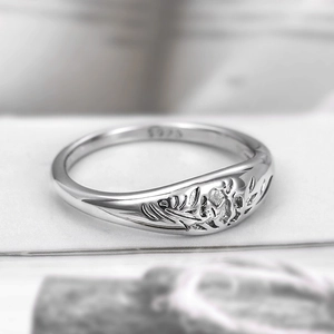 Macro shot of S925 sterling silver ring showing intricate floral pattern and purity stamp