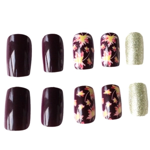 Short square press-on nails set featuring maple leaf designs and gold glitter finish