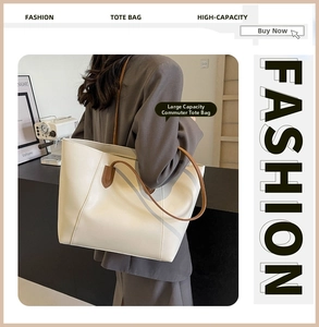 Detail of a cream faux leather tote bag with slim brown straps on a model in urban setting