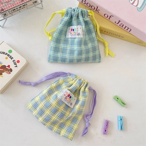 Detail of colorful plaid cotton drawstring pouches for cosmetics and small travel items