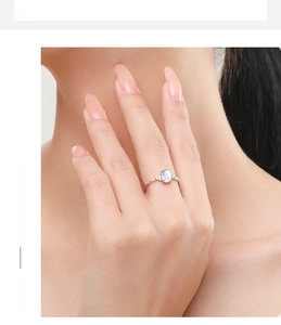 Close-up of S925 sterling silver ring with oval moonstone on model's finger