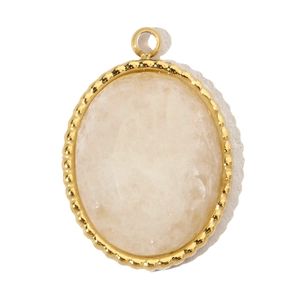 Close-up of a gold oval pendant featuring a white translucent gemstone in a macro view