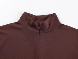 Detail of a dark brown V-neck slim fit athletic top with zipper and mock neck collar