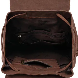 Internal view of dark brown canvas backpack with large main compartment and zip pockets