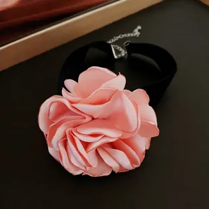 Pink velvet rose choker necklace with elegant layered petals and adjustable black ribbon strap