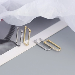 Detailed view of silver and gold S925 sterling silver rectangular hoop earrings with zircon
