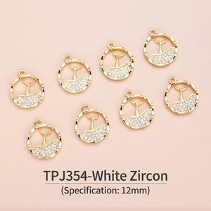 Macro shot of 12mm 18K gold plated whale tail charms with white zircon inlays