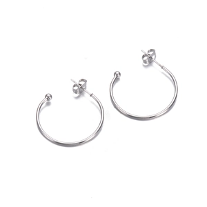Detailed view of silver stainless steel C-shaped hoop earrings with butterfly backs