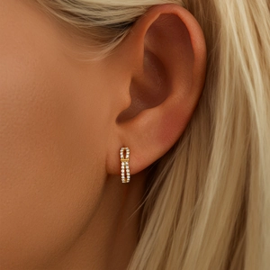 Detailed close-up of luxurious double-row gold-plated pavé diamond huggie hoop earrings