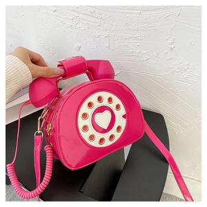 Creative pink telephone-shaped crossbody bag with a retro dial and spiral handset handle