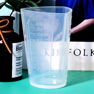 Macro view of silicone measuring cup with Oz and Cups markings and pour spout