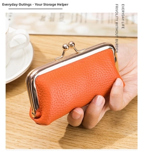 Detailed shot of an orange pebbled leather mini purse with gold metal clasp closure