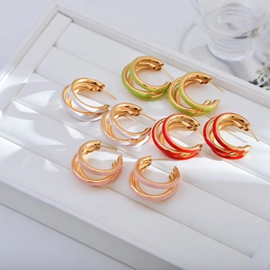 Three-layer colorful enamel C-shape hoop earrings in gold finish on jewelry tray
