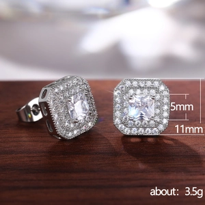 Classic silver square zircon stud earrings with pavé setting on dark wood background