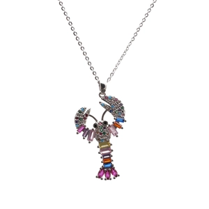 Macro detail of the lobster pendant featuring colorful zircon stones and silver chain