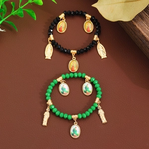 Religious layered bracelet set with green and black crystal beads and golden Virgin Mary icons