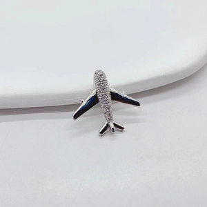 Luxe crystal-encrusted airplane pendant in silver metal finish on a white background