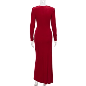 Back view of elegant long-sleeve red velvet dress with split hem for formal evening wear