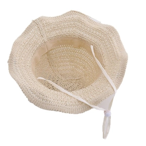 Inside view of beige woven straw sun hat with adjustable windproof drawstring strap