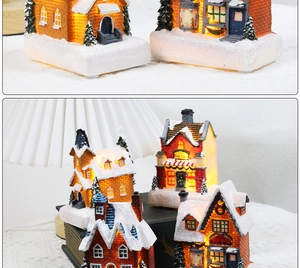 Close-up of lighted Toy Land Christmas house with sparkling snow and warm LED glow