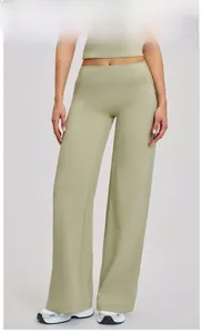 Macro detail of moss green high-waisted wide-leg yoga pants with elastic waistband