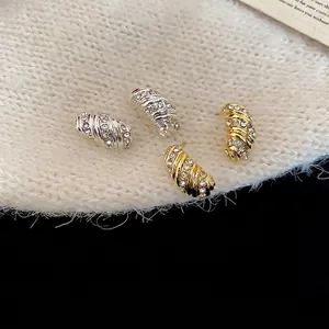 Elegant twisted rhinestone stud earrings set in gold and silver finish for women