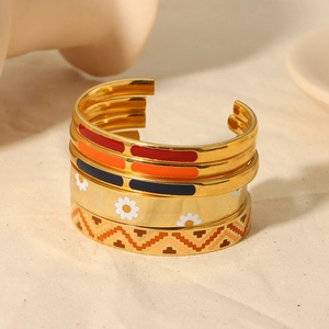Five-piece gold enamel cuff bracelet set with colorful daisy and geometric patterns
