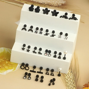 Detailed set of black surgical steel stud earrings with rose, heart, and crescent moon icons