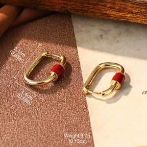 Detail view of red enamel geometric earrings with dimensions 2.1cm x 1.4cm and weight 3.7g