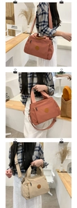 Detail view of large capacity nylon tote bag in brick red and beige colors for women