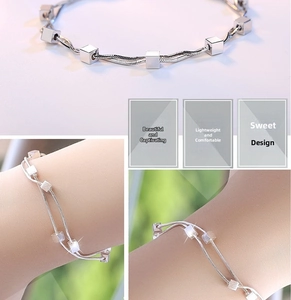 Close-up of a double-layered silver snake chain bracelet with polished square beads