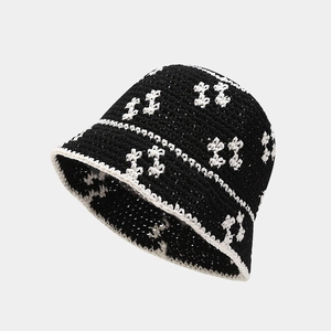 Detailed knit texture of handmade crochet bucket hat with floral pattern and wavy brim