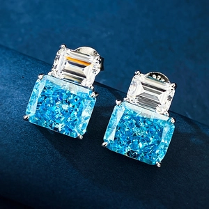 Macro shot of S925 silver earrings with radiant sky blue and white rectangle gemstones