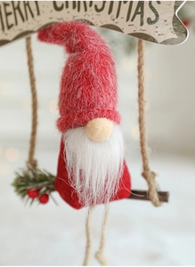 Macro detail of Christmas gnome hanging ornament with red knit hat and white beard