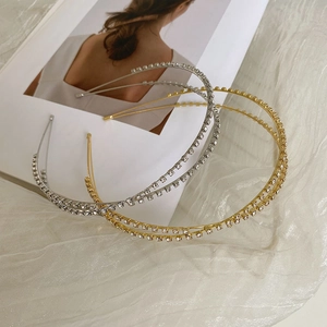 Detailed view of gold and silver alloy headbands with sparkling rhinestones on fabric