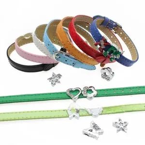 Macro shot of colorful PU leather belts featuring rhinestone heart and star sliders