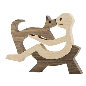 Handcrafted wooden sculpture showing person hugging a dog with natural wood grain detail
