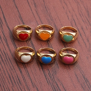 Close-up of adjustable enamel heart rings in red, orange, green, white, blue, and pink colors